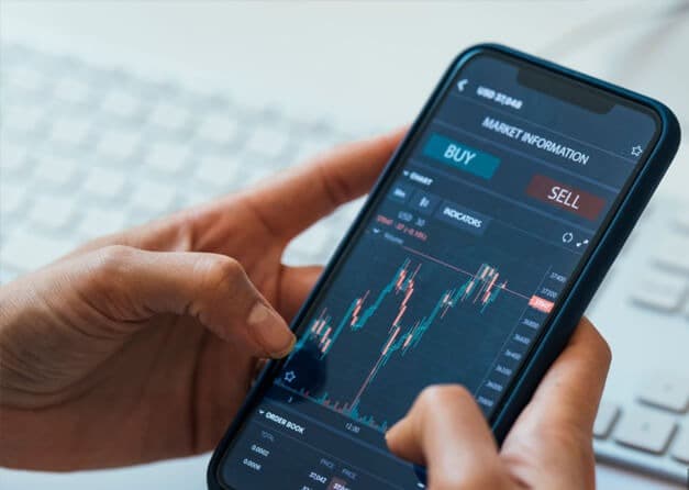 A person checking stock market data and placing a trade on a smartphone.